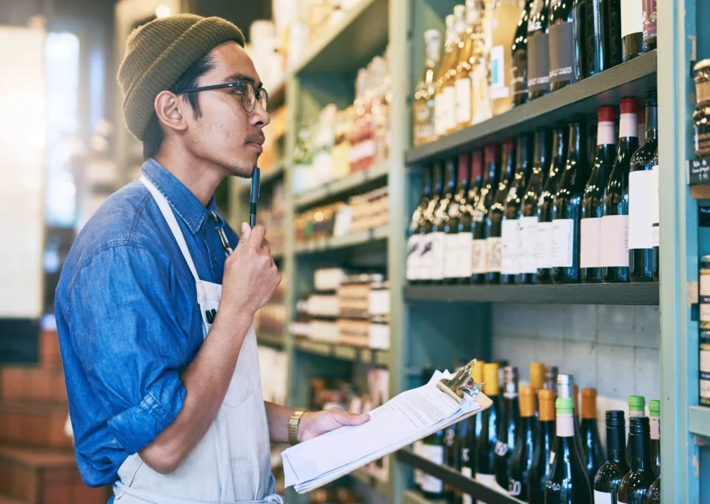 Worker surveys stock in bottle-shop. Emails are an essential tool in creating a diverse marketing strategy.