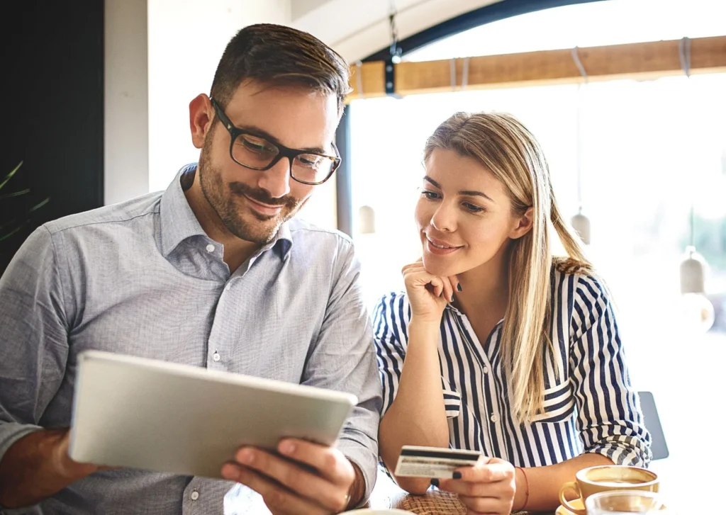 Two people look over a digital tablet. Diverse tools to use in your eCommerce business.