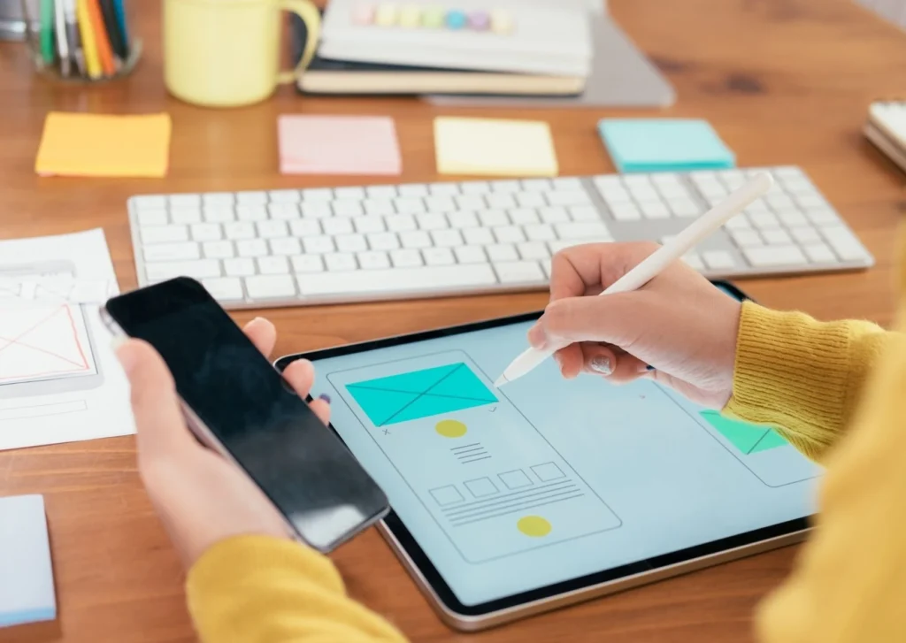 Image shows a person working on a tablet and a iphone. What are the key points of interaction design?