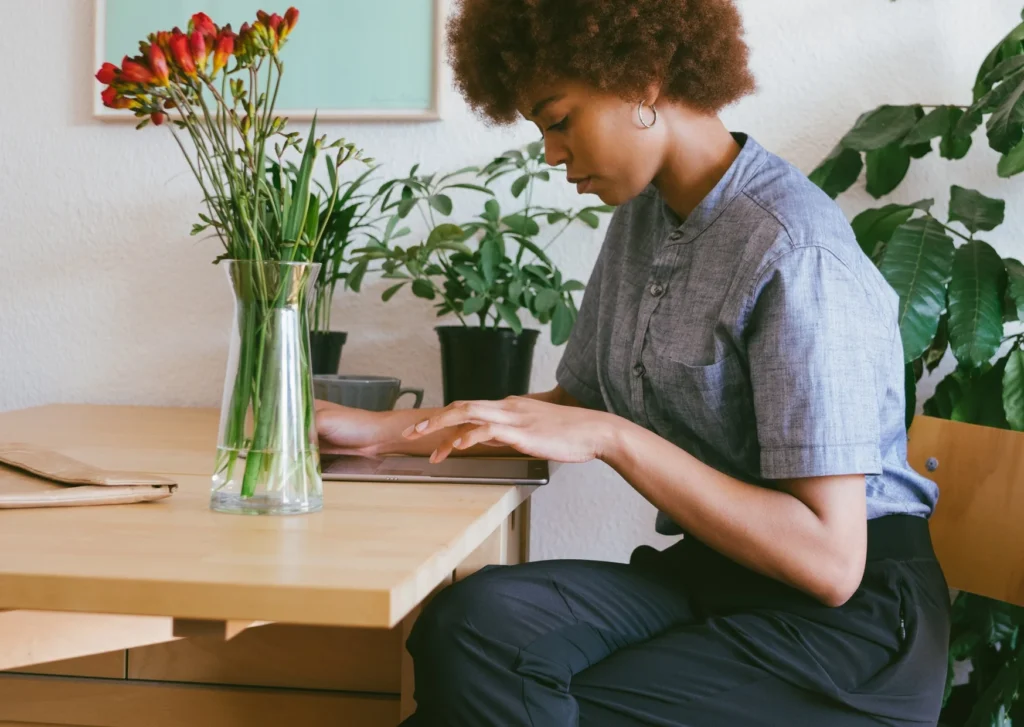 Vase of Red Flowers with Female Employee