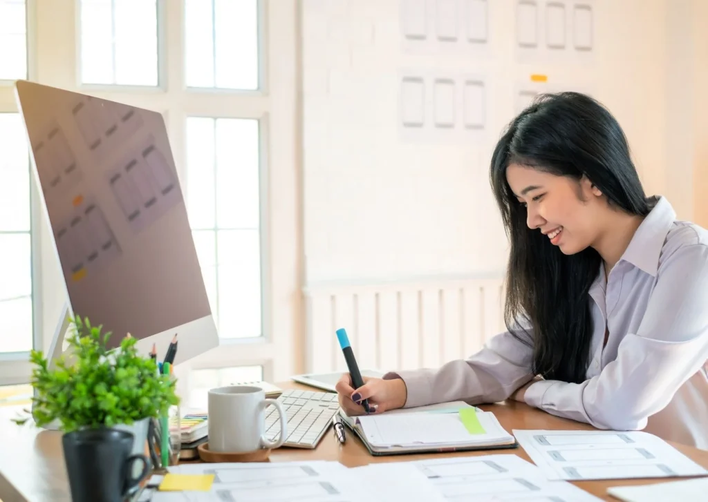 A woman in front of a desktop. Make sure your page loads fast and avoid any tricky typography.