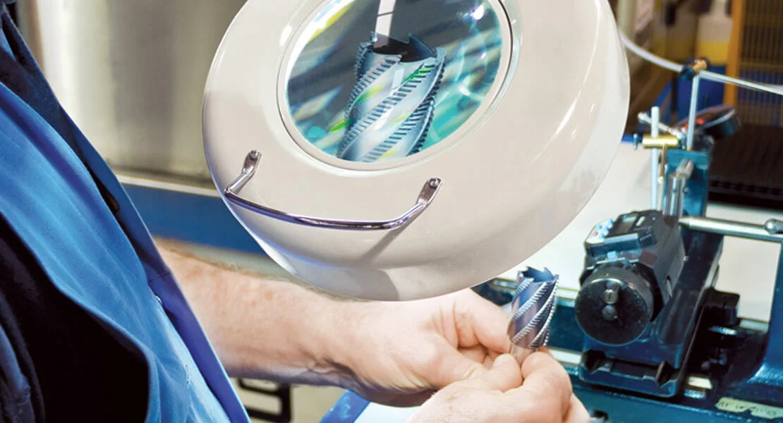 Man Analyzing a Tool With Magnifying Glass
